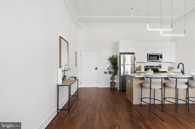 a kitchen with stainless steel appliances a refrigerator and a stove top oven