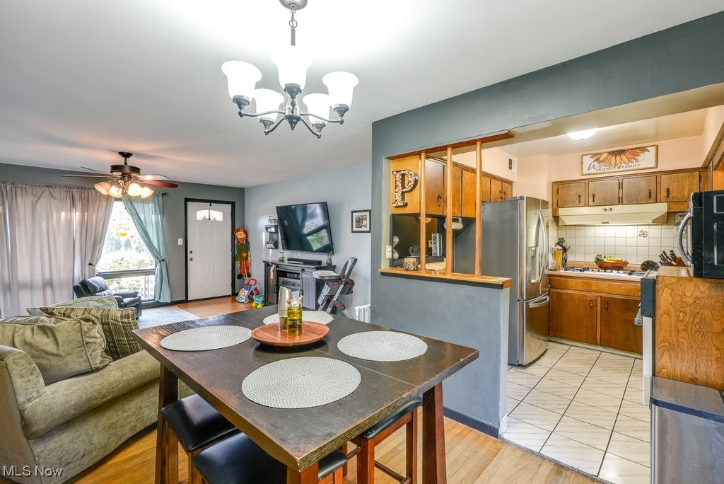 333 East Caston Road Akron, OH 44319 - Photo 12 of 42 Dining area with light hardwood / wood-style flooring and ceiling fan with notable chandelier