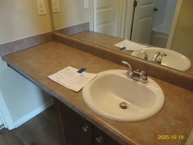 a bathroom with a sink and a mirror