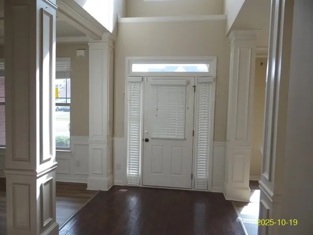 a view of a hallway with wooden floor