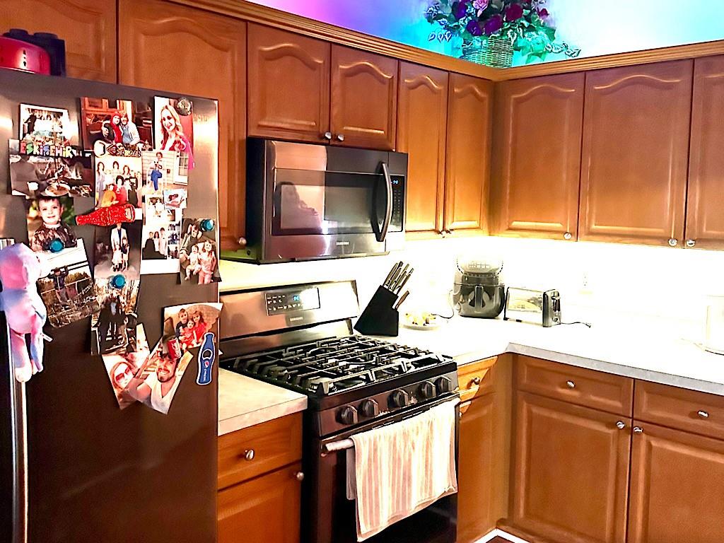 2431 Apalachee Run Way Dacula, GA 30019 - Photo 3 of 17 a kitchen with stainless steel appliances granite countertop a stove and cabinets