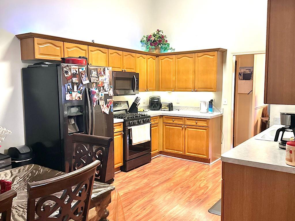 2431 Apalachee Run Way Dacula, GA 30019 - Photo 4 of 17 a kitchen that has a sink stainless steel appliances and cabinets
