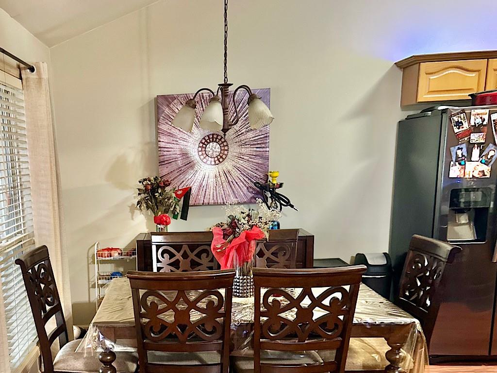 2431 Apalachee Run Way Dacula, GA 30019 - Photo 5 of 17 a view of a dining room with furniture and chandelier