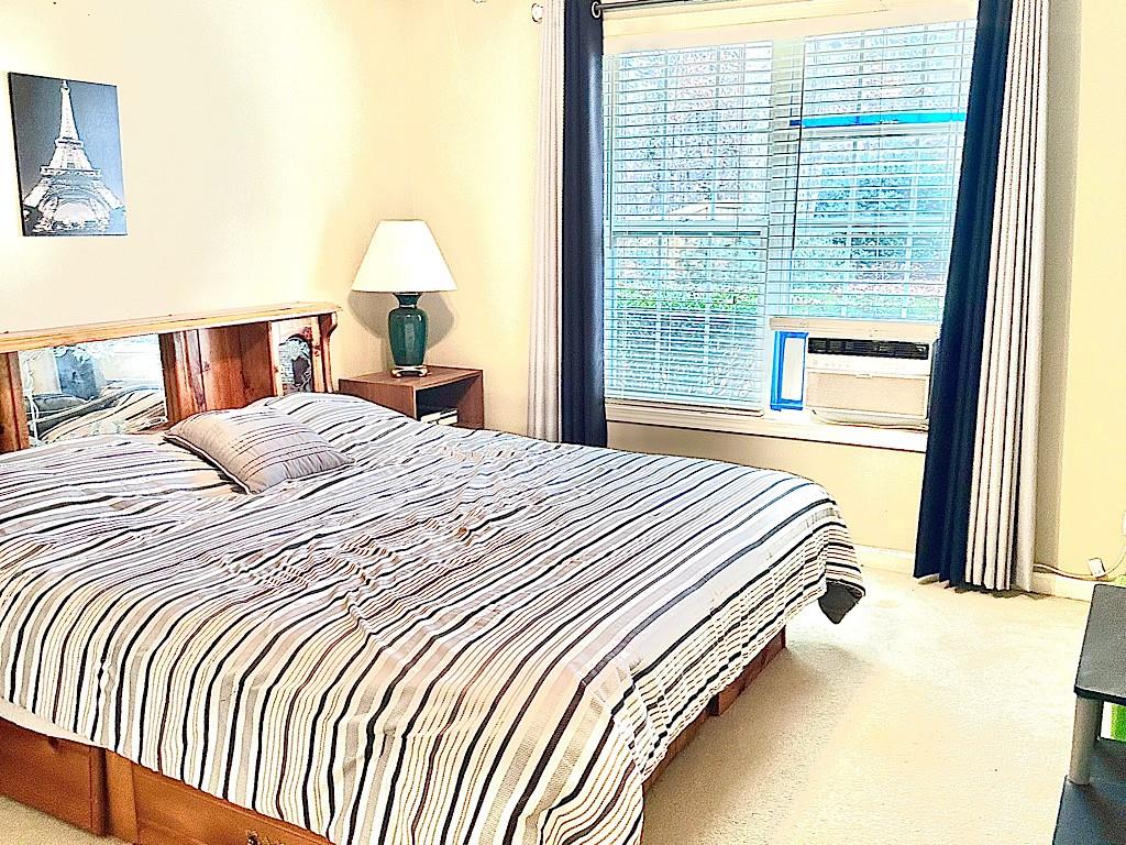 2431 Apalachee Run Way Dacula, GA 30019 - Photo 10 of 17 a bedroom with a bed and a large window