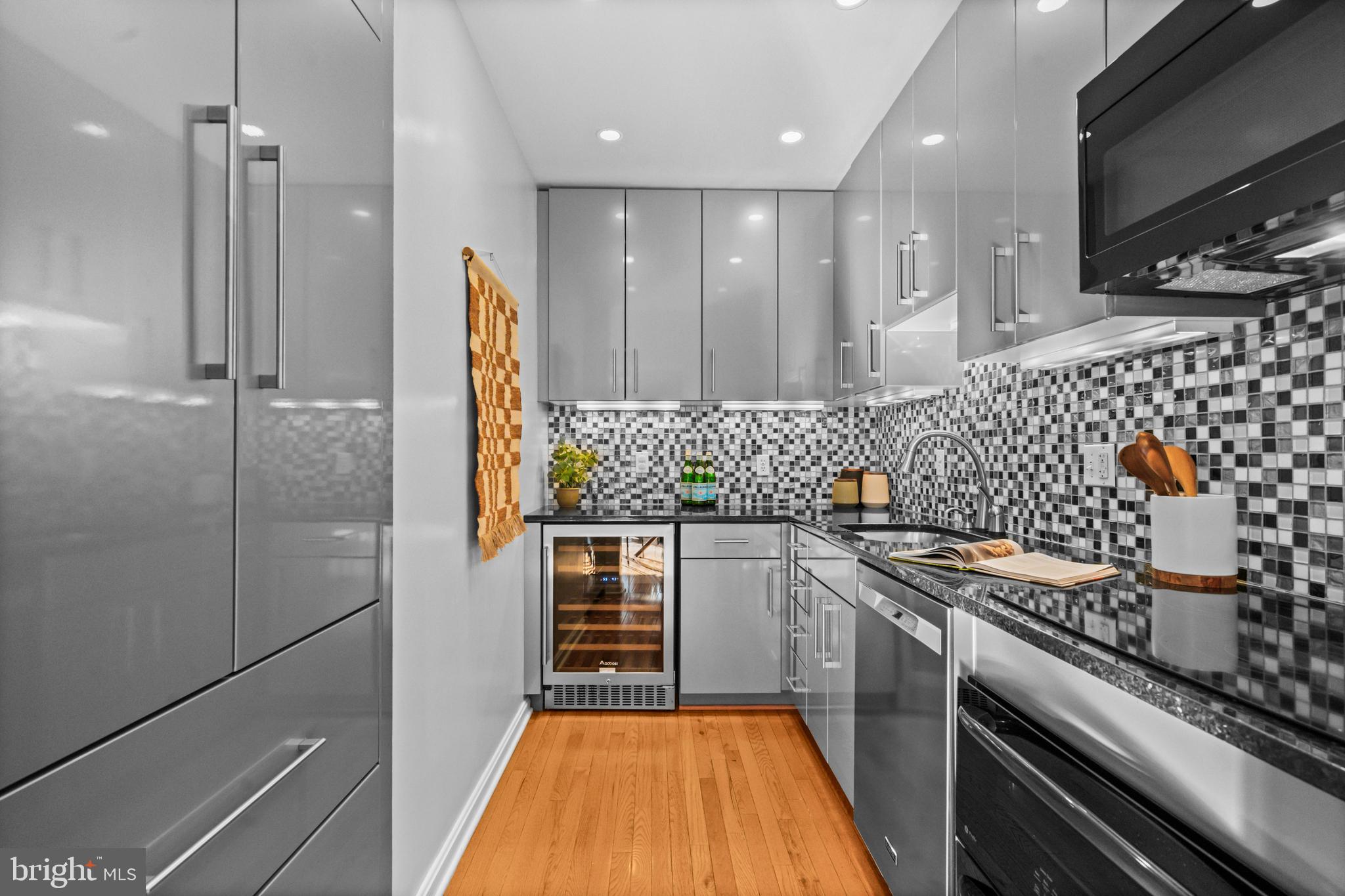 3225 Grace Street Northwest, Unit 219 Washington, DC 20007 - Photo 14 of 45 a kitchen with stainless steel appliances granite countertop a stove a sink and a refrigerator