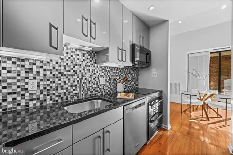 a kitchen with a sink a stove and cabinets
