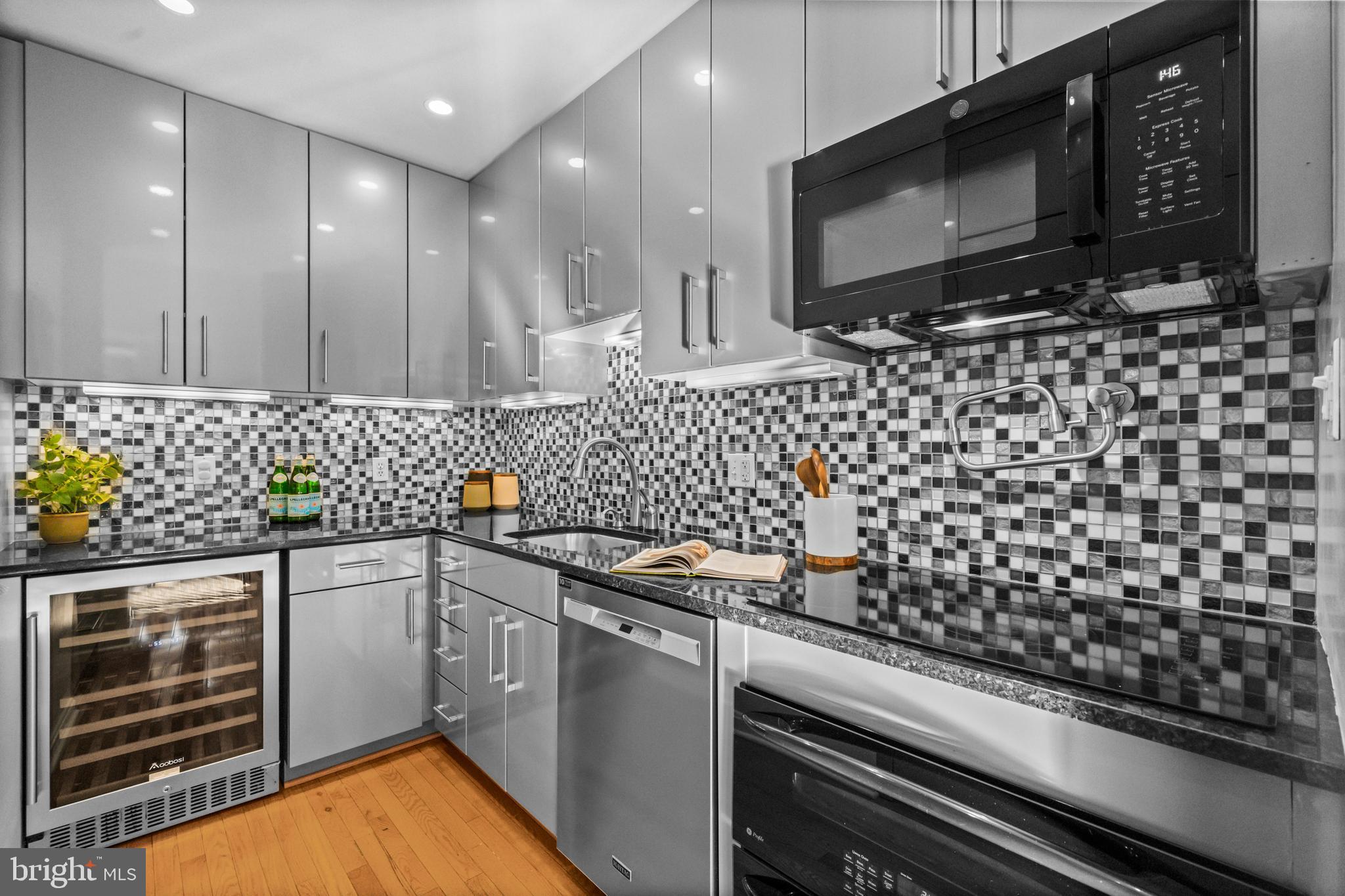 3225 Grace Street Northwest, Unit 219 Washington, DC 20007 - Photo 16 of 44 a kitchen with granite countertop a sink stove and cabinets