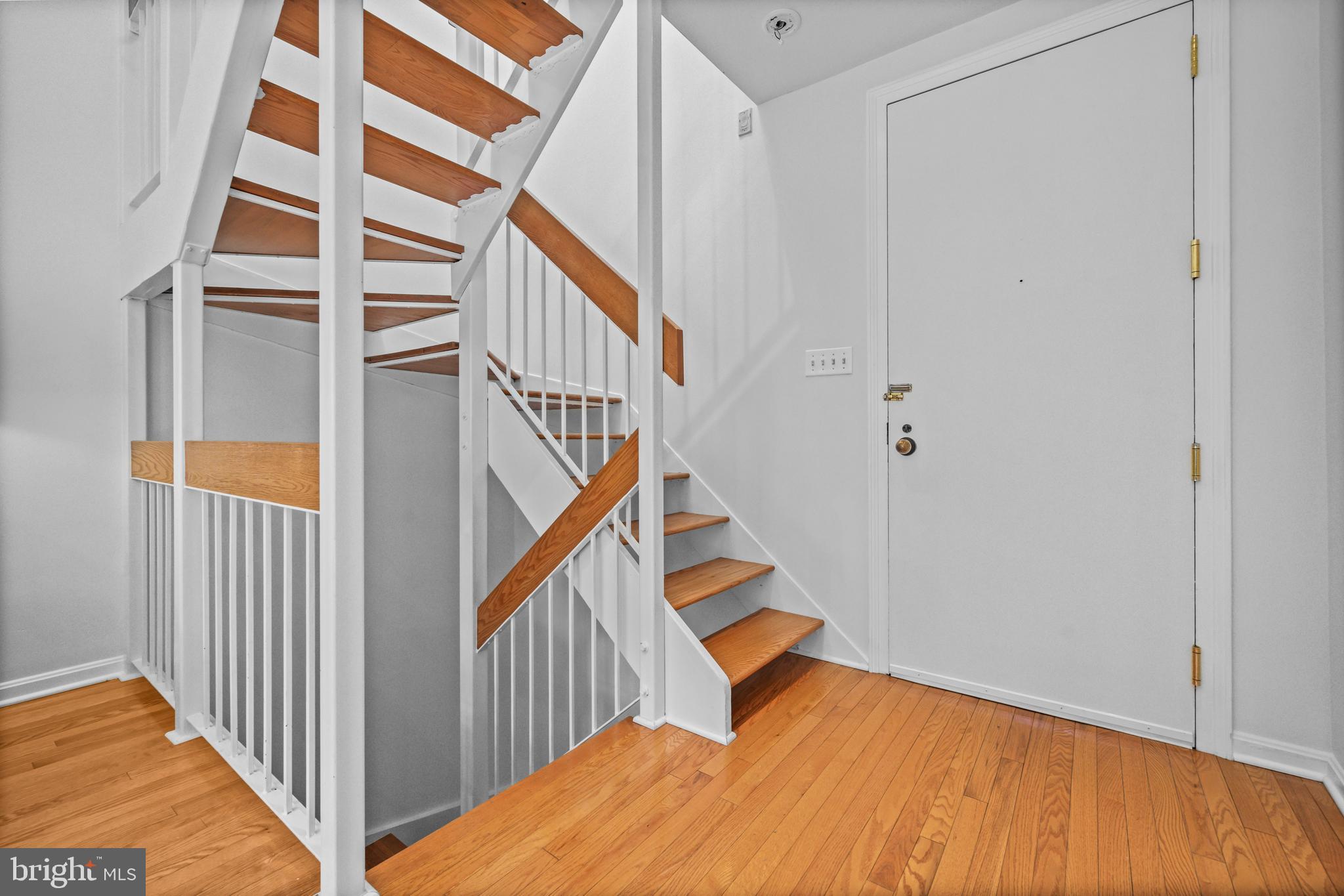 3225 Grace Street Northwest, Unit 219 Washington, DC 20007 - Photo 18 of 45 a view of entryway with wooden floor and stairs