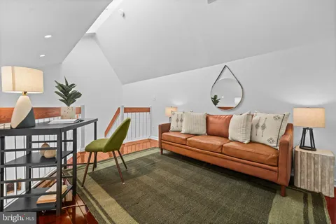 a living room with furniture a rug and a chandelier