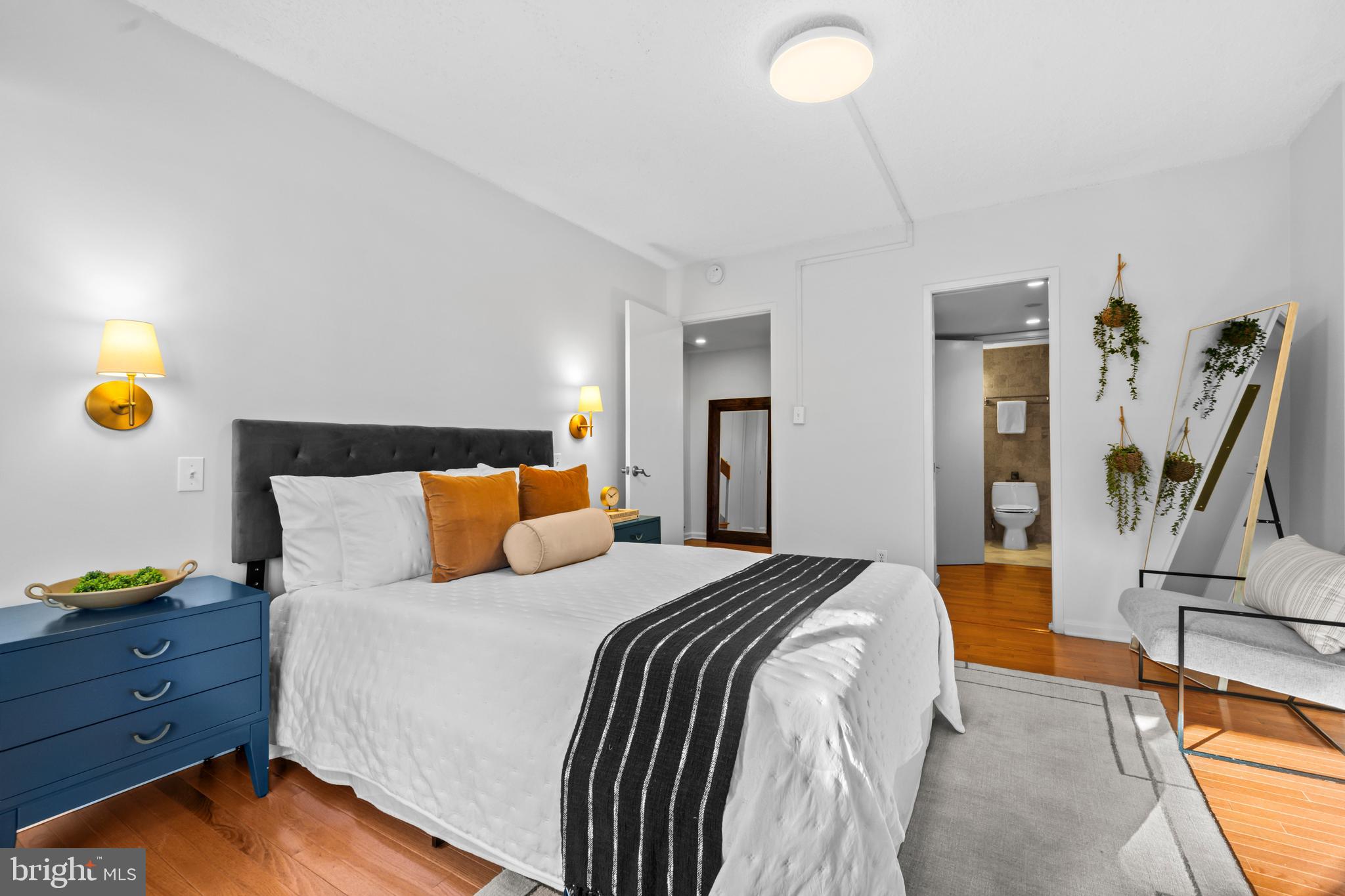 3225 Grace Street Northwest, Unit 219 Washington, DC 20007 - Photo 26 of 44 a bed room with a bed and a potted plant