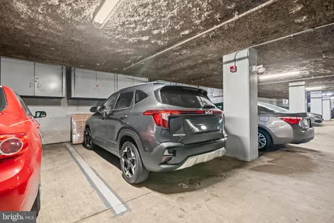 a view of parking garage with cars parked