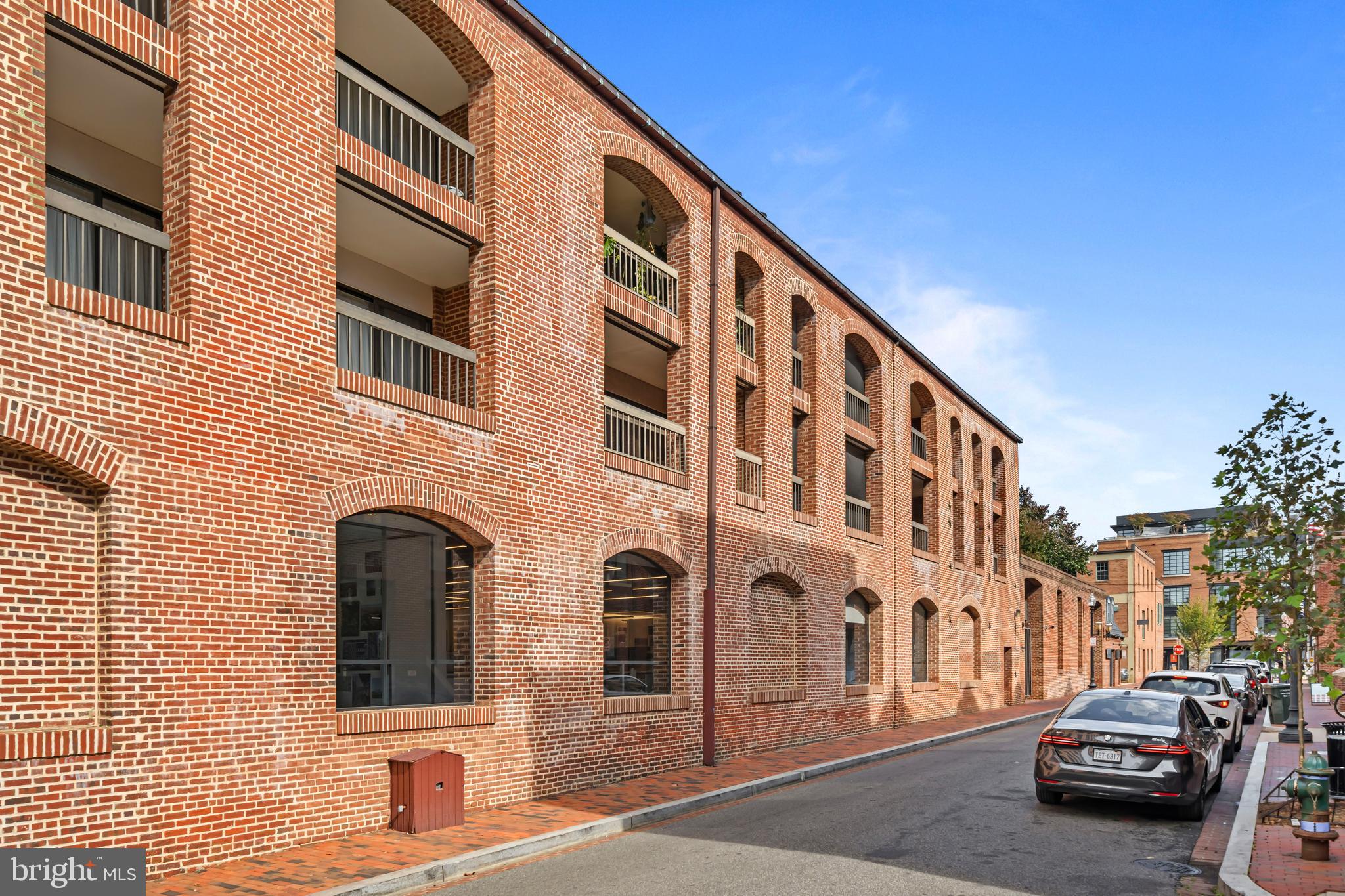3225 Grace Street Northwest, Unit 219 Washington, DC 20007 - Photo 43 of 44 a couple of cars parked in front of brick building