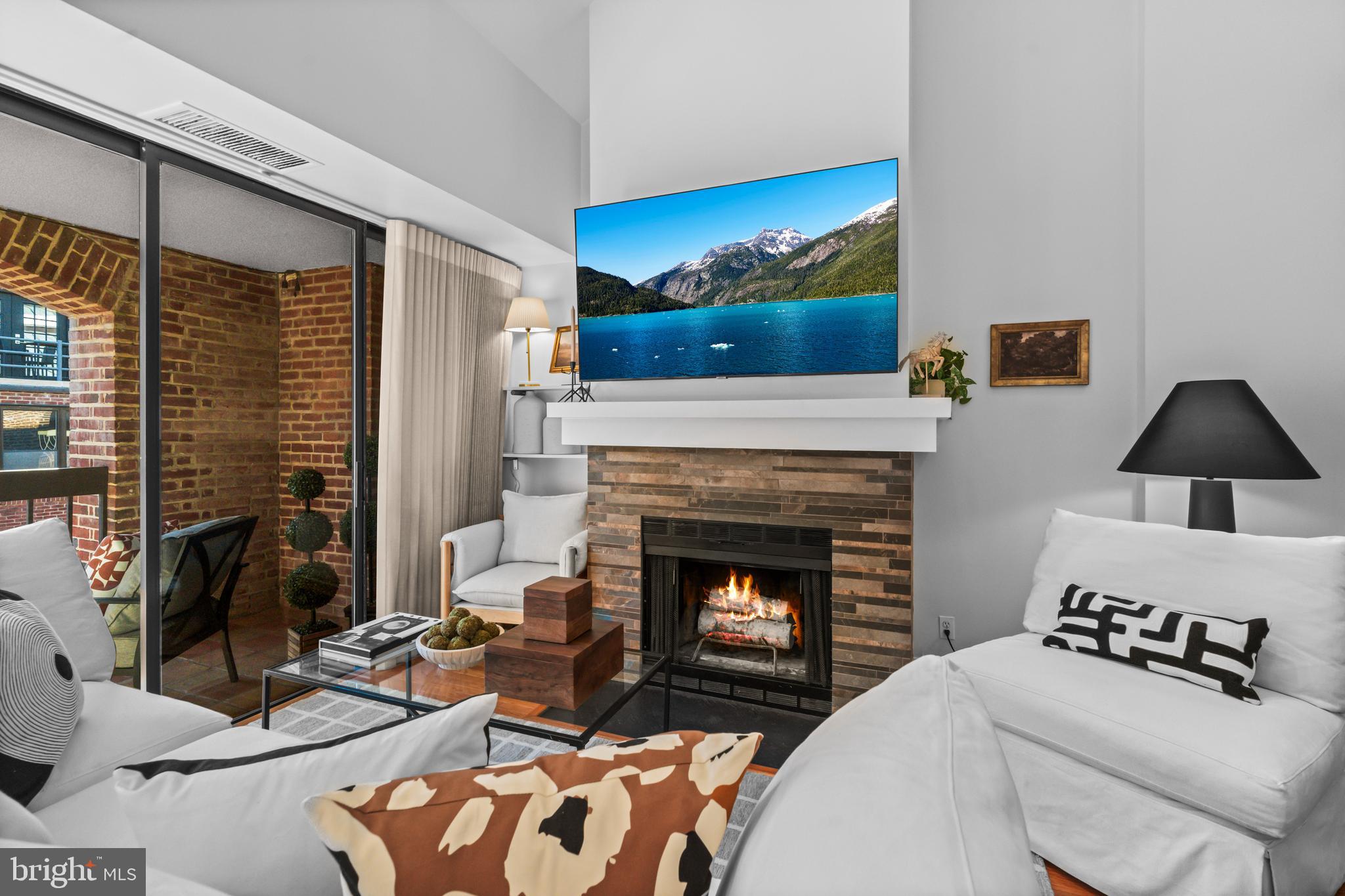 3225 Grace Street Northwest, Unit 219 Washington, DC 20007 - Photo 5 of 44 a living room with furniture and a fireplace