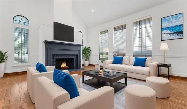 a living room with furniture fireplace and window