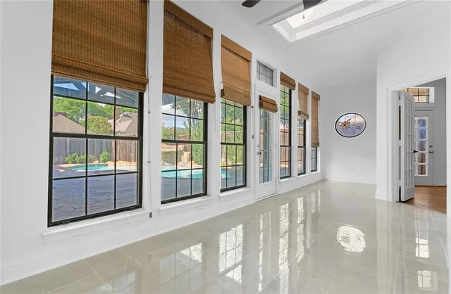 a bedroom with a large bed and a painting on the wall