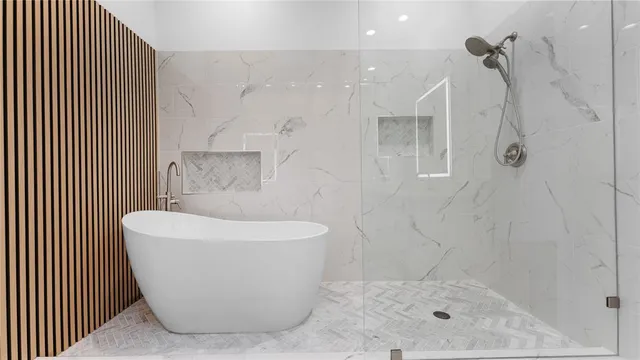 a bathroom with a bathtub and shower