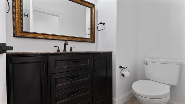 a view of a workspace with furniture and a potted plant