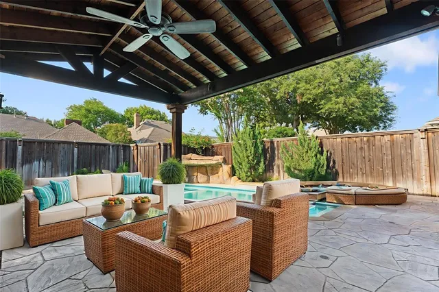 a building outdoor space with patio furniture and potted plants