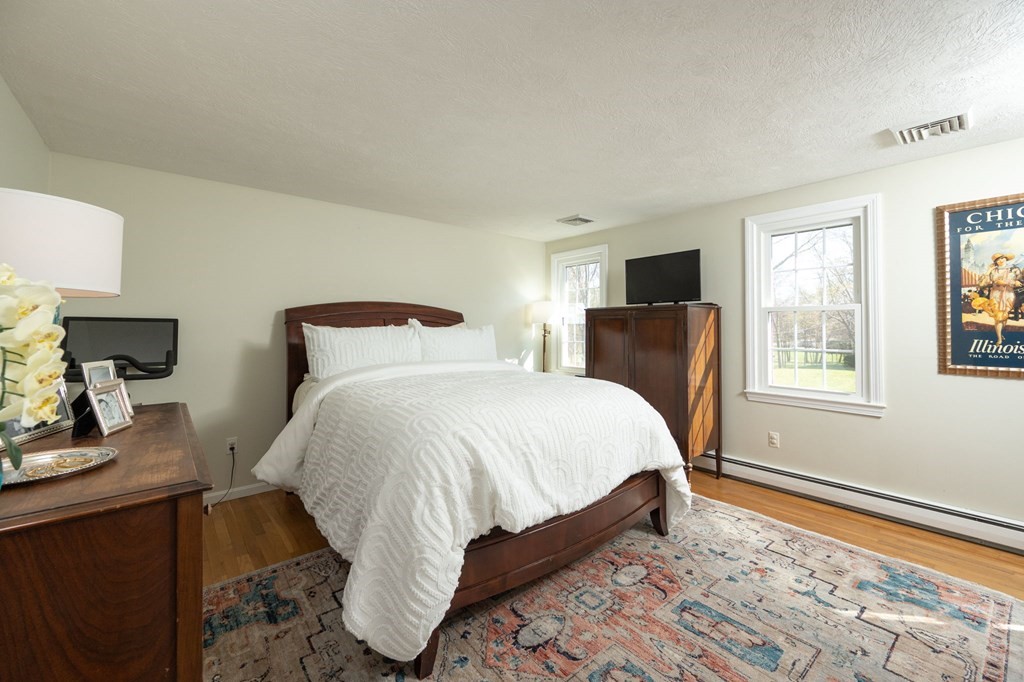 5 Chatham Circle Hingham, MA 02043 - Photo 12 of 30 a bedroom with a bed and wooden floor
