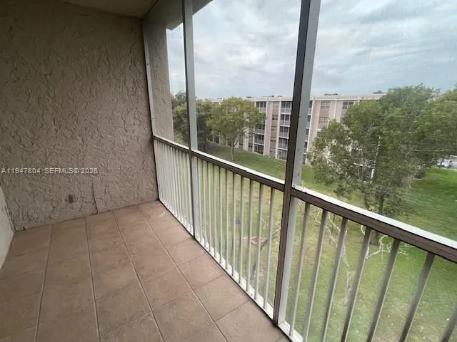 a front view of a building with a garden