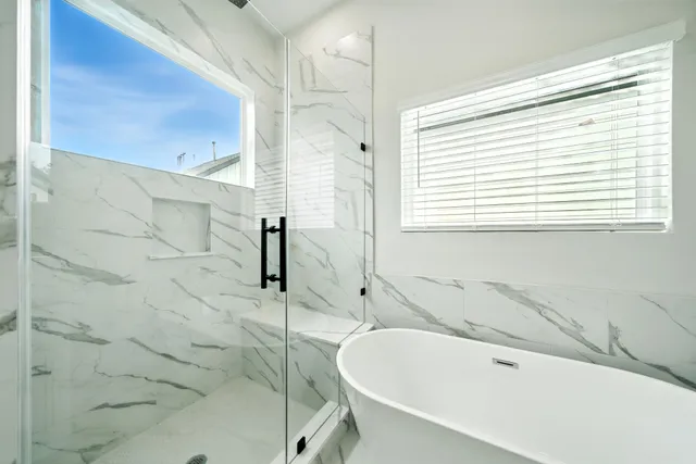 a bathroom with a bathtub and a shower