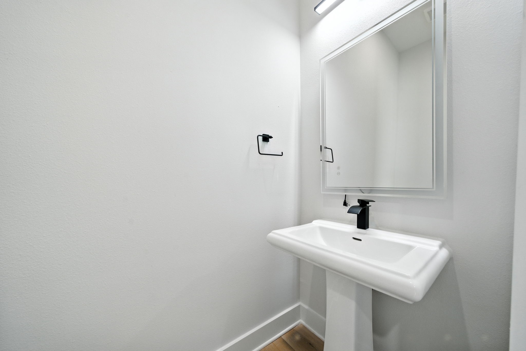 2306 Hoskins Drive, Unit B Houston, TX 77080 - Photo 6 of 27 a white sink sitting under a bathroom mirror