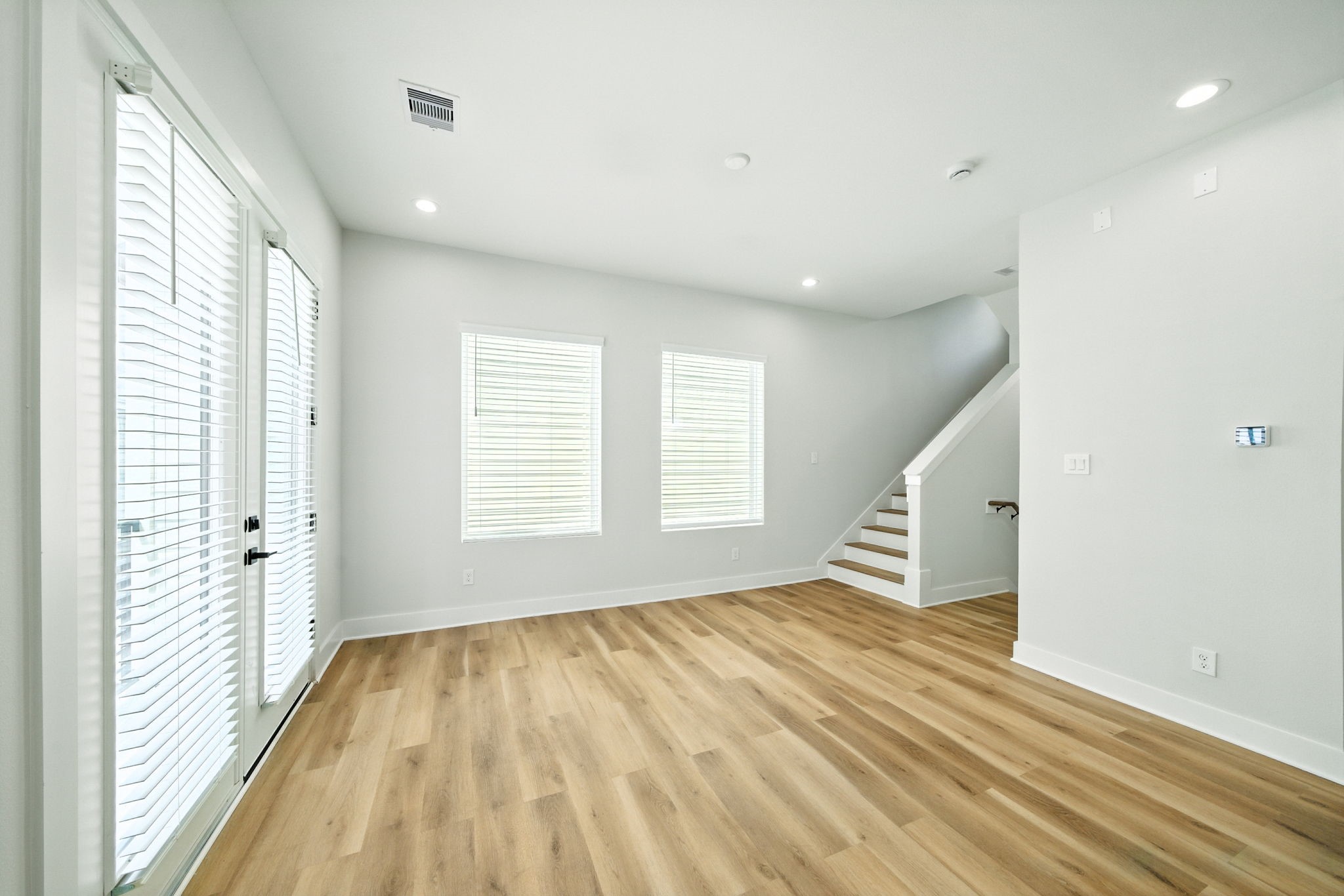 2306 Hoskins Drive, Unit B Houston, TX 77080 - Photo 9 of 27 a view of empty room with wooden floor and fan