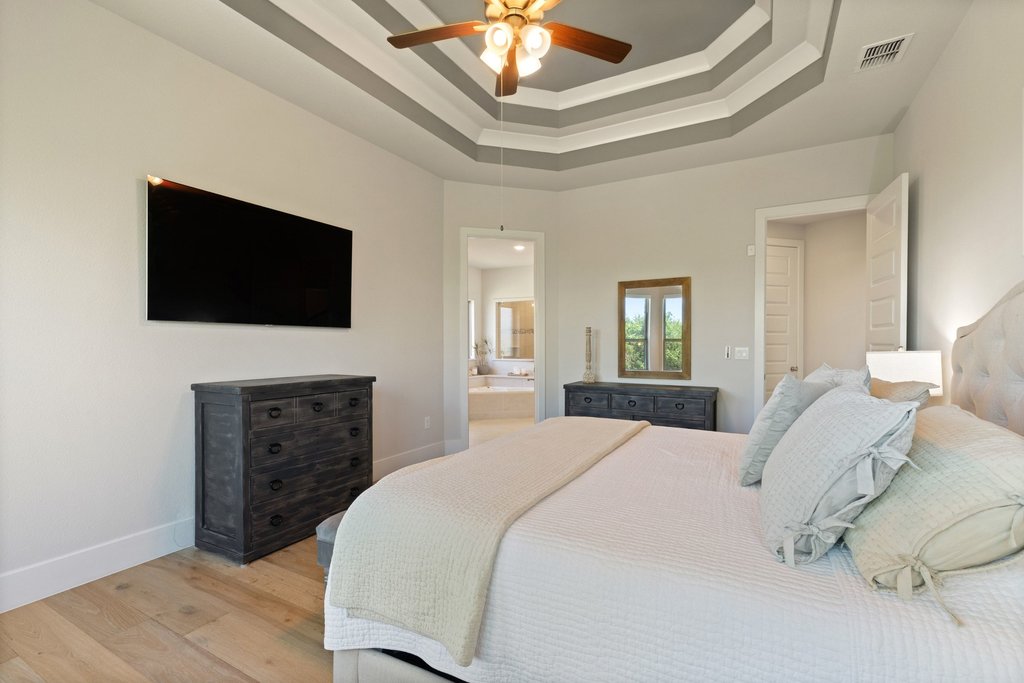 741 Rawson Bend Austin, TX 78738 - Photo 16 of 40 Ample room for a king sized bed under tall tray ceilings.