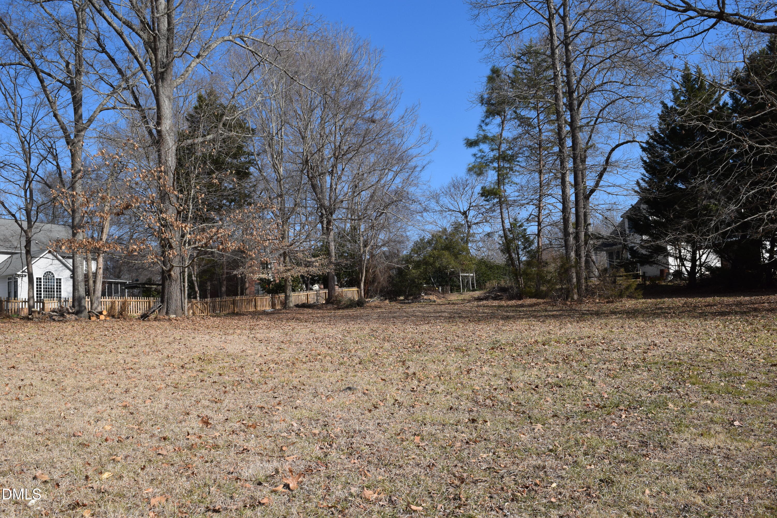 2391 Jade Court Graham, NC 27253 - Photo 2 of 4 a backyard of a house with large trees