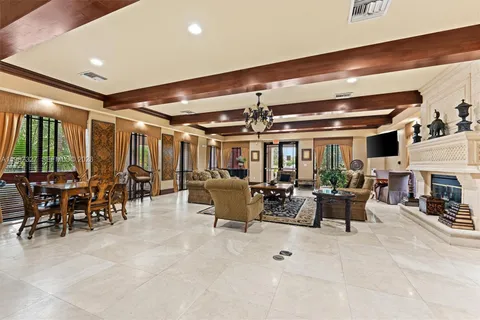 a large kitchen with granite countertop a sink and a stove top oven