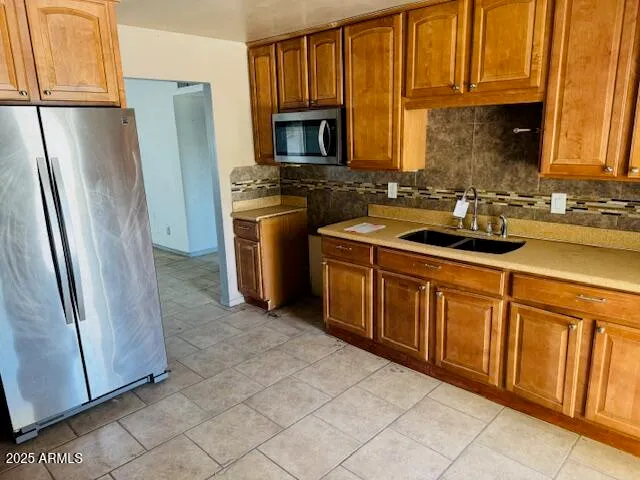 a kitchen with stainless steel appliances granite countertop a refrigerator stove and sink