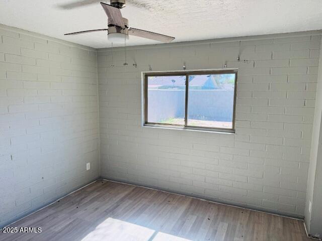 1737 West Pecan Road Phoenix, AZ 85041 - Photo 10 of 14 a view of an empty room with a window and wooden floor