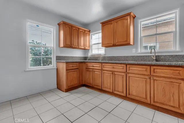 a kitchen with a sink window and cabinets