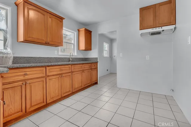 a view of a kitchen with white cabinets