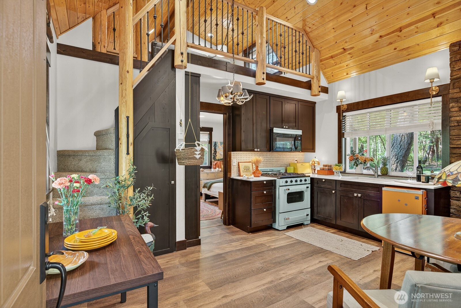 a large kitchen with a table and chairs in it