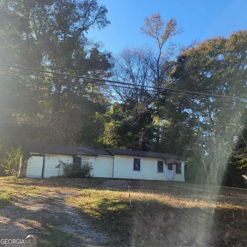 a view of a backyard with large tree