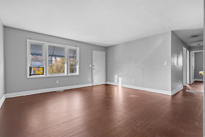 685 Bolton Road Northwest Atlanta, GA 30331 - Photo 2 of 21 a view of an empty room with window and wooden floor