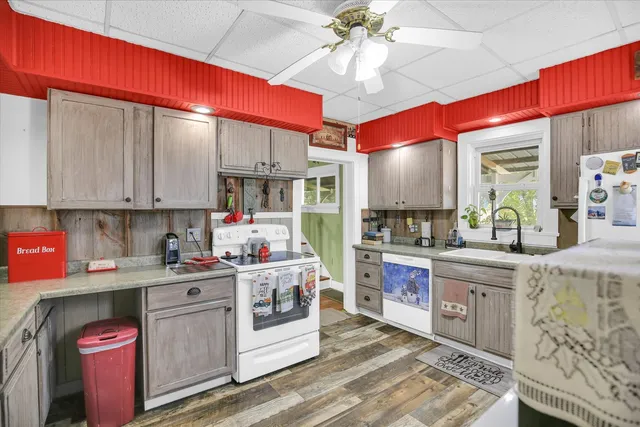a bathroom with a granite countertop tub a sink and a large mirror