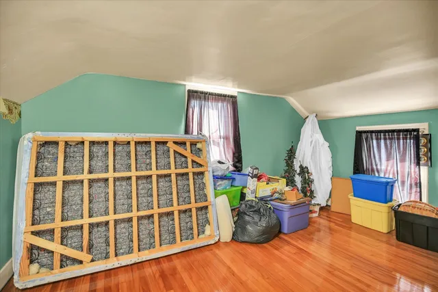 a view of a room with a window and wooden floor