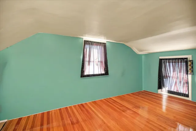 a bedroom with furniture and a wooden floor