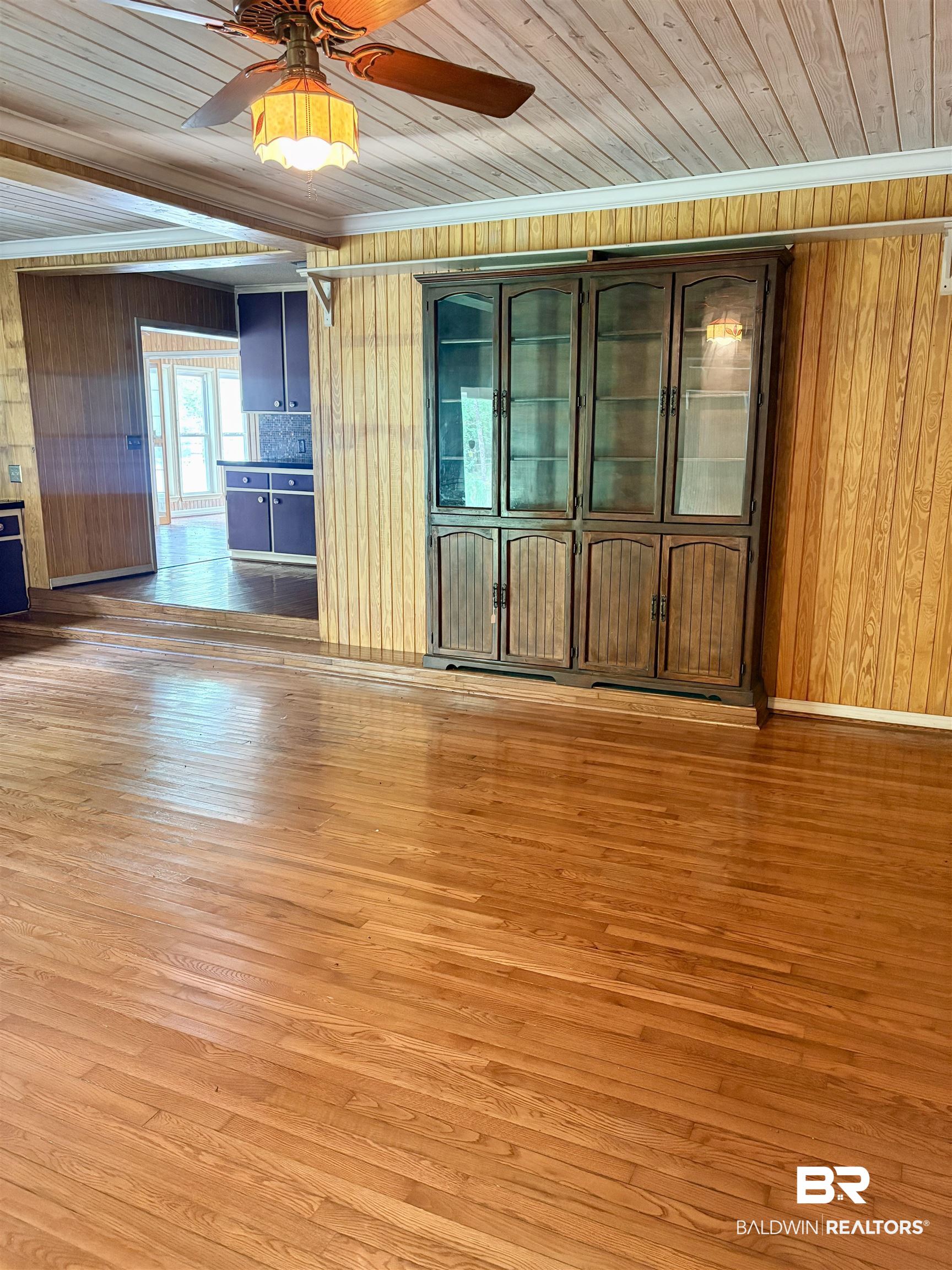 1018 Bates Road Evergreen, AL 36401 - Photo 6 of 21 Unfurnished room with wood walls, a ceiling fan, light wood-style floors, and wood ceiling