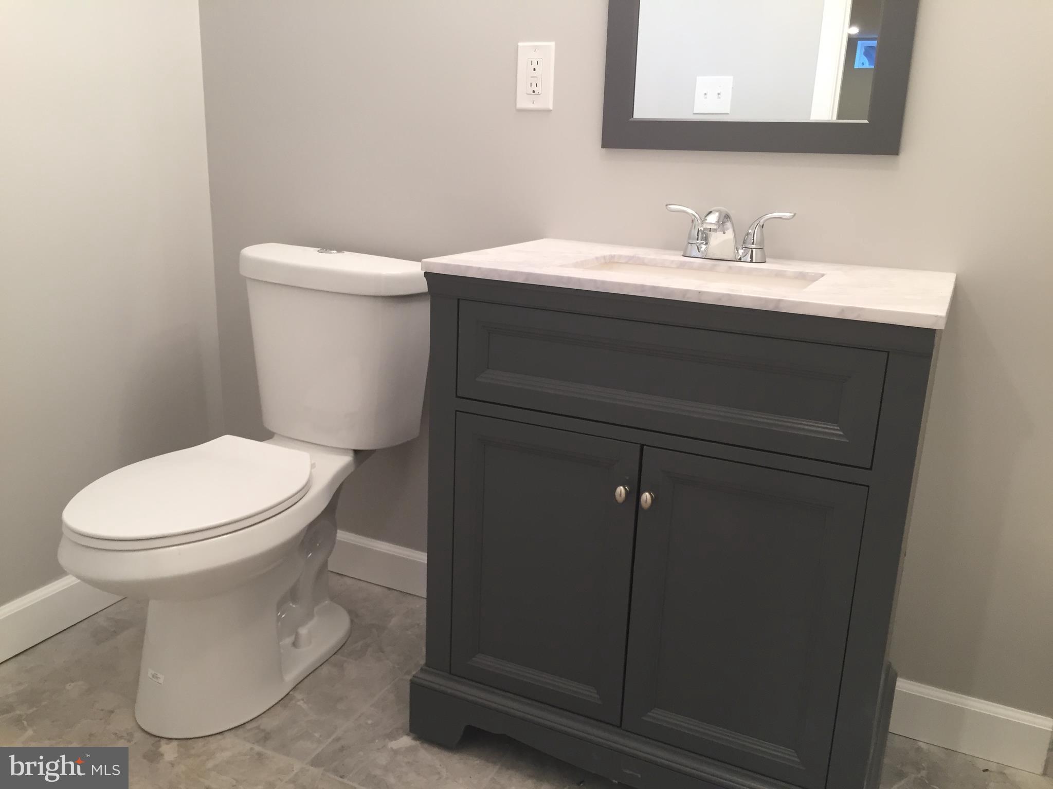 3157 Jeffland Road Baltimore, MD 21244 - Photo 17 of 19 a bathroom with a toilet sink and mirror