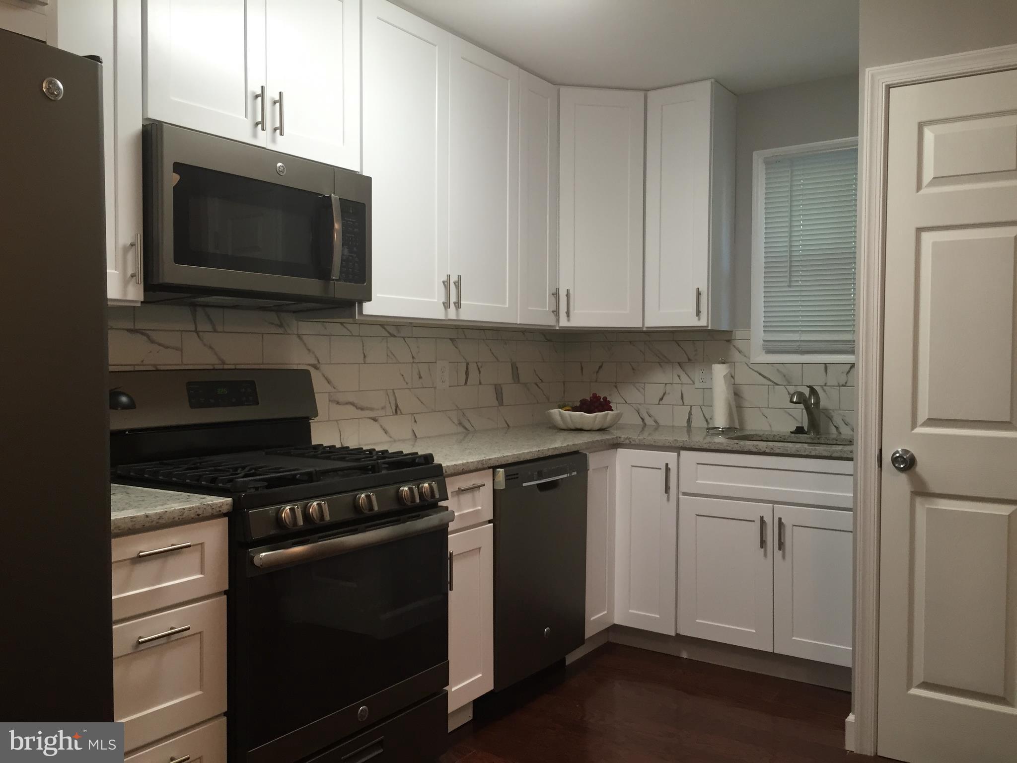 3157 Jeffland Road Baltimore, MD 21244 - Photo 6 of 19 a kitchen with stainless steel appliances granite countertop a stove and a microwave
