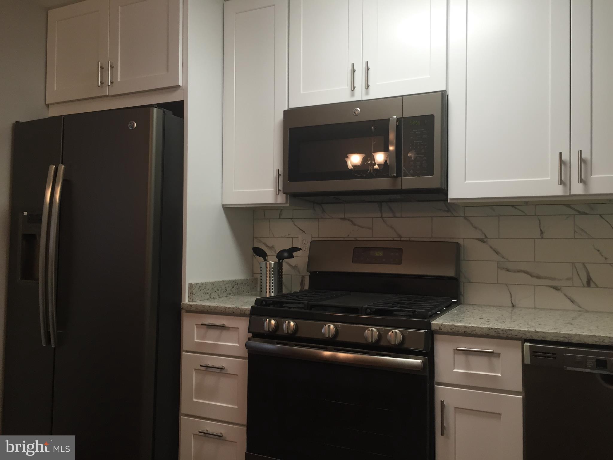 3157 Jeffland Road Baltimore, MD 21244 - Photo 7 of 19 a kitchen with a stove and a microwave