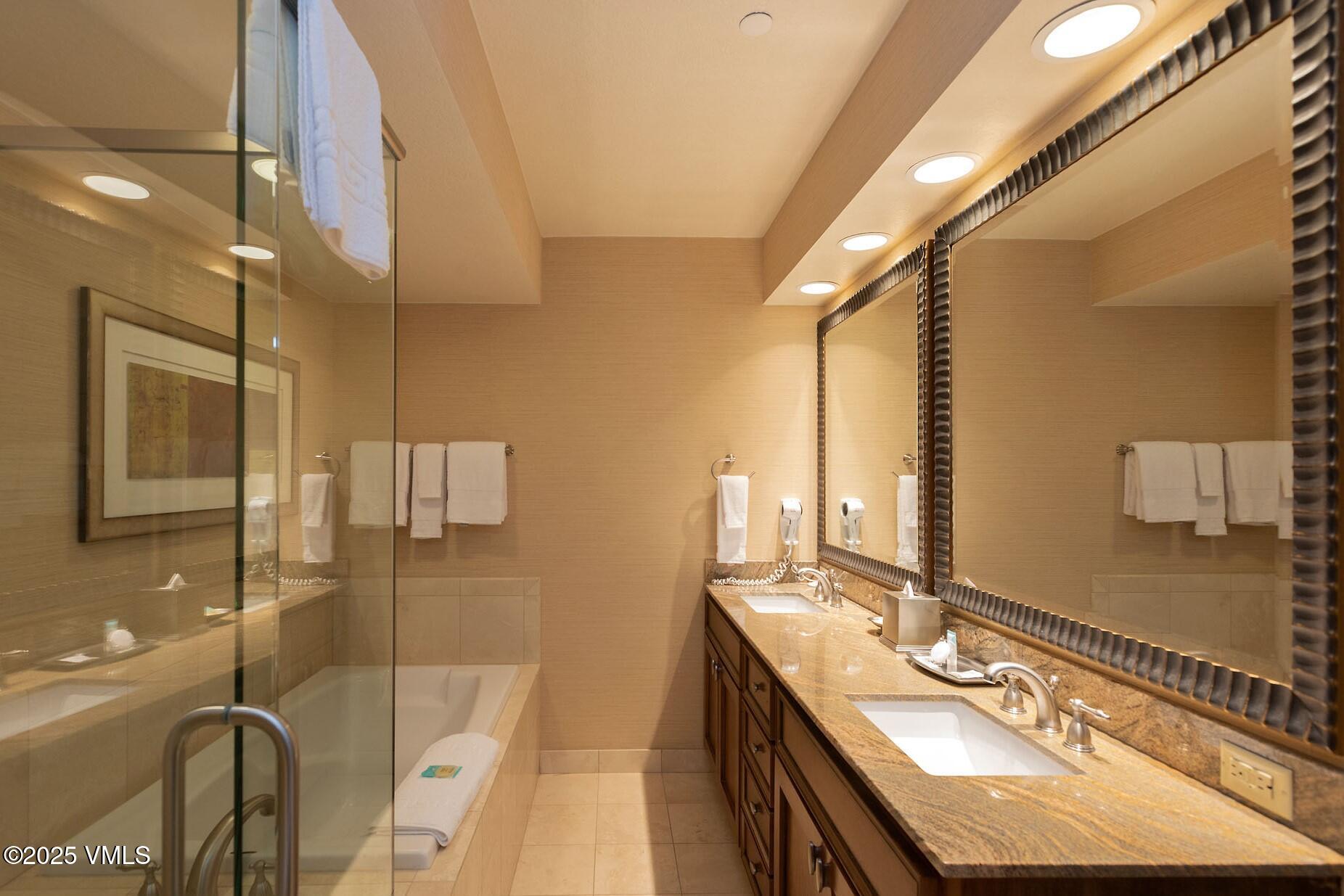 210 Offerson Road, Unit 3044 Beaver Creek, CO 81620 - Photo 16 of 21 a bathroom with a sink a mirror and a shower