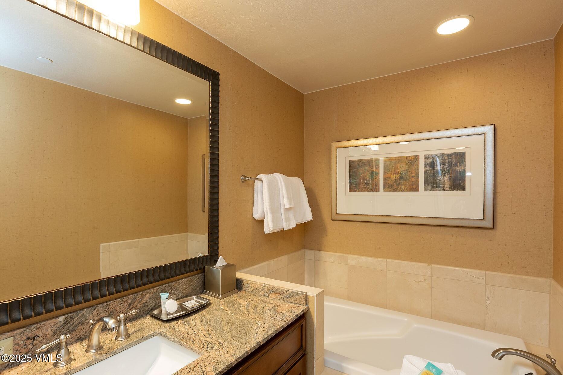 210 Offerson Road, Unit 3044 Beaver Creek, CO 81620 - Photo 20 of 21 a bathroom with a granite countertop sink and a mirror