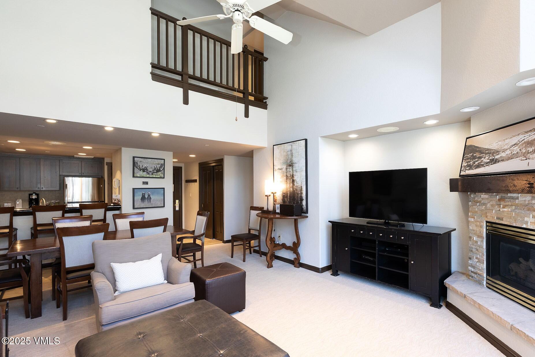 210 Offerson Road, Unit 3044 Beaver Creek, CO 81620 - Photo 2 of 21 a living room with fireplace furniture and a flat screen tv