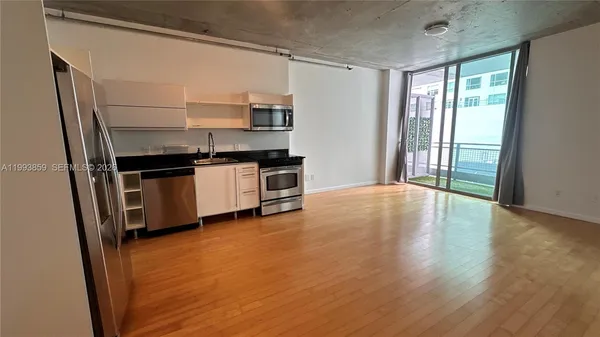 a kitchen with stainless steel appliances a stove a sink and a refrigerator