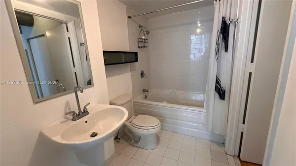 a bathroom with a bathtub and toilet