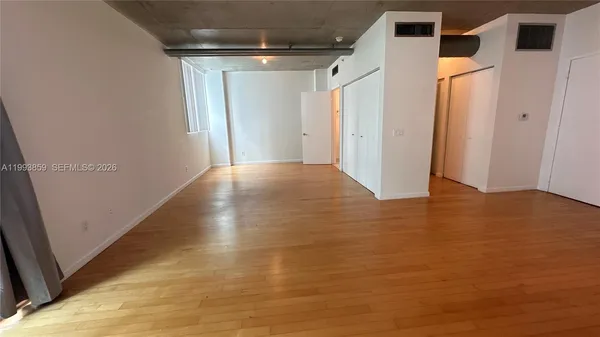 a view of kitchen with furniture and wooden floor